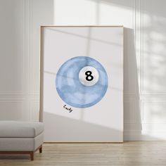 a blue and white pool ball with the number eight on it in front of a chair