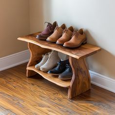 several pairs of shoes are lined up on a wooden shelf