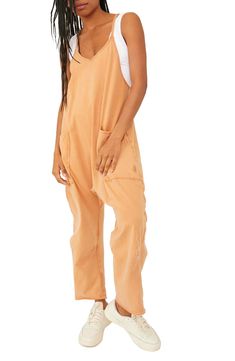 Keep it casual and relaxed in this slouchy jumpsuit designed in a baggy fit with handy pockets. 55" length; 23 1/2" inseam; 17" leg opening (size Medium) Pull-on style V-neck Racerback Back zip pocket; front patch pockets 95% cotton, 5% elastane Machine wash, tumble dry Imported Slouchy Jumpsuit, Casual Summer Rompers, Summer Onesies, Baggy Overalls, Dressy Clothes, Trendy Overalls, Loose Overalls, Womens Onesie, Womens Jumpsuits Casual