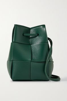 Re-imagined as a bucket bag, this version of Bottega Veneta's 'Cassette' style is sized to fit just your smallest essentials, like a lipstick and a few cards. It's made from strips of leather woven using the brand's signature intrecciato technique and has slim, knotted straps. Wear yours cross-body. Designer Square Bucket Bag With Removable Pouch, Luxury Leather Bucket Bag With Phone Pocket, Luxury Leather Bucket Bag With Mobile Phone Bag, Luxury Intrecciato Weave Crossbody Bucket Bag, Designer Bucket Bag With Intrecciato Weave, Leather Bucket Shoulder Bag With Woven Detail, Designer Rectangular Bucket Bag With Intrecciato Weave, Luxury Bucket Bag With Intrecciato Weave, Designer Woven Leather Bucket Bag