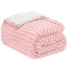 the pink and white blanket is folded on top of each other, with a fuzzy edge