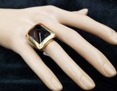 FASHION ITALIAN DESIGN 18K YELLOW SOLID GOLD BLACK ONYX RING CENTER NATURAL BLACK ONYX SIZE 20X15 GORGEOUS BLACK ONYX CLEAN ,VERY NICE CUT ,LIVELY STONE.NICE LUSTER. RING size 6.5 Ring measure one inch long 28mmx21mm Ring weighs 19.7 grams Retail value $8,500 net . Appraisal available Designer Black Rings For Anniversary, Designer Black Enamel Rings For Gift, Designer Black Ring With Black Enamel, Designer Black Enamel Ring, Gold Gemstone Rings For Evening, Designer Yellow Gold Rings For Evening, Gold Rings With Polished Finish For Evening, Designer Black Jewelry With Polished Finish, Formal Gold Onyx Rings