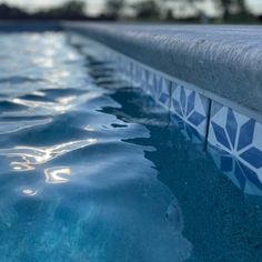 an empty swimming pool with clear blue water