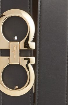 A removable double-Gancio buckle adds golden sheen to a handsome belt crafted from high-quality leather. 1 1/4" belt width; 3 1/2" x 1 3/4" buckle Leather Made in Italy Modern Leather Belt Buckles With Gold Buckle, Modern Leather Belt Buckle With Gold Buckle, Modern Leather Belt Buckle With Gold Detail, Luxury Belts With Buckle Closure For Formal Occasions, Luxury Formal Belt With Buckle Closure, Leather Belts With Gold-tone Rectangular Buckle, Gold Formal Belt With Removable Feature, Classic Leather Belt Buckles With Gold-tone Hardware, Gold Leather Belts And Suspenders With Removable Belt