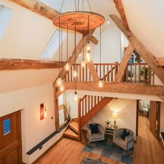 an overhead view of a living room with wooden beams and chandeliers hanging from the ceiling