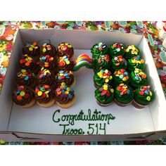 cupcakes are arranged in the shape of trees and rainbows on top of each other