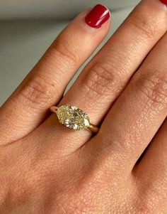 a woman's hand with a diamond ring on it