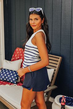 - Sail away to paradise with this chic stripe top! - Unlined knit material with a ribbed texture and a striped pattern - A crew cut neckline - A sleeveless cut - A figure hugging silhouette that ends in a straight hemline Chic Ribbed Tank Top For Beach, Striped Ribbed Tops For Beach, Striped Ribbed Tops For The Beach, Summer Striped Tops With Ribbed Neckline, Striped Summer Tops With Ribbed Neckline, White Ribbed Tank Top For The Beach, Striped Ribbed Tank Top, Striped Ribbed Cotton Tank Top, Casual White Tank Top With Contrast Stripes