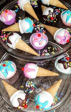 several cupcakes with ice cream and sprinkles on them are arranged in cones