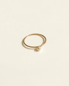 Featuring a dainty stacking ring with a tiny crystal pearl in the center of the ring. Made in 14k gold-fill, she's tarnish-resistant, showerproof, and safe for sensitive skin. Just keep her away from chemicals such as hand sanitizer, soap, and lotion. She looks beautiful stacked or as a solo ring. …………………………………. D E T A I L S • Available from US 5 to 7• Pearl width measures 3mm• Keep away from chemicals such as lotion, soap, and hand sanitizer• Tarnish-resistant, waterproof, and safe for sensiti Everyday Pearl Ring With Charm, Minimalist Stackable Adjustable Pearl Ring, Adjustable Stackable Minimalist Pearl Ring, Minimalist Pearl Ring With Single Diamond For Promise, Minimalist Pearl Promise Ring With Single Diamond, Dainty Pearl Ring With Single Diamond For Promise, Dainty Stackable Pearl Promise Ring, Minimalist Pearl Promise Ring With Diamond, Minimalist Everyday Pearl Ring With Round Band