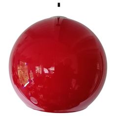 a large red ball sitting on top of a white floor