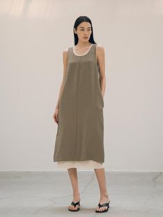 This is a casual and minimal dress by Siyazu that is made out of high quality and sturdy fabric. With refined design detail and trendy mood, you can style it for your casual and comfortable daily outfit.- Minimal U neckline- Natural wrinkle of the fabric with soft touch- Curved voluminous silhouette on the hip- Slits on the back hem Olive Sleeveless Midi Dress, Chic Sleeveless Khaki Midi Dress, Khaki Sleeveless Midi Dress For Spring, Versatile Layering Dresses For Spring, Modern Sleeveless Maxi Dress For Work, Khaki Sleeveless Dress For Work, Versatile Spring Layering Dresses, Minimalist Sleeveless Daywear Dress, Chic Cotton Dresses For Layering