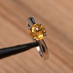 It is a natural citrine ring. The main stone is 7mm*7mm round cut, weight about 1.25 carats.The basic metal is sterling silver and plated with rhodium.To change the metal to a solid gold (white/rose) or platinum is also available, please ask for a quotation if you want.You can also go to my shop Home for more elegant rings: https://www.etsy.com/shop/godjewelry?ref=hdr_shop_menuMore citrine rings: https://www.etsy.com/shop/godjewelry?ref=seller-platform-mcnav&section_id=20715039Customization Citrine Rings, Round Cut Solitaire Engagement Ring, Elegant Rings, Sunflower Ring, Alexandrite Engagement Ring, Engagement Ring For Women, Alexandrite Ring, London Blue Topaz Ring, Citrine Ring