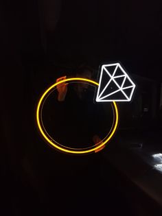 a neon ring with a diamond on it in the dark