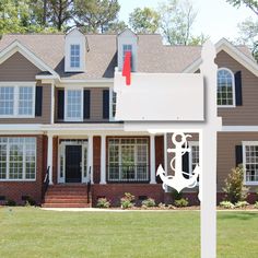 a house with a sign in front of it that has an anchor and flag on it