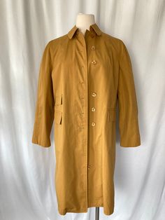 "Classic 1960's 1970's Misty Harbor Ltd. \"Buoy Cloth\" mustard yellow women's rain coat trench coat knee length, soft light yellow lining, slit pockets on either side and inside left pocket.  65% Dacron polyester 35% Combed Cotton Treated with Zepel Good vintage condition with no rips or stains Tag show size 12 Petite Measurements (laying flat): Chest: 21\" Back Length w/o Collar: 39\" Sleeve: 23 1/2\" Our items are vintage, older and/or pre-loved and may show signs of age. Items may have some Vintage Raincoat, Yellow Boho Dress, Yellow Vintage Dress, Yellow Polka Dot Dress, Women's Trench Coat, White Boho Blouse, 70s Skirt, Yellow Lace Dresses, Vintage Dress 60s