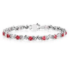 This beautiful 10k white gold diamond bracelet features 14 oval cut  ruby gemstones. 28 round prong set diamonds weigh 0.15ctw, color J-K-L, clarity I2-I3. ruby gemstones measure 4x3mm and weigh 2.75ctw. Red Diamond Oval Bracelet, Red Oval Diamond Bracelet, Red Diamond Bracelet With Gemstone, Red Diamond Oval Tennis Bracelet, Red Round Bracelets With Diamond Accents, Red Bracelets With Diamond Accents, Red Diamond Accents Bracelet For Anniversary, Red Diamond Accents Bracelets For Anniversary, Red Diamond Accent Bracelets For Anniversary