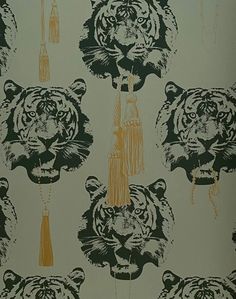 a wallpaper with tiger heads and tassels on it