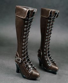 a pair of brown high heeled boots with laces and buckles on the side