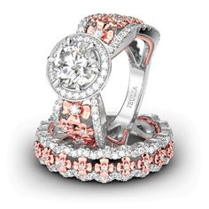 two wedding rings with pink and white diamonds