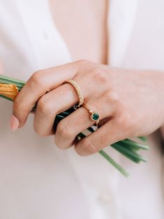 A round Emerald is delicately bezel set in a gold hammered band, along with a bezel set diamond and gold Dew Drop detail.This dainty everyday ring can be worn as a stackable set or on its own. Size: 7 Emerald Gemstone measures 5mm Diamond carat weight 0.03 14k yellow Gold Looking for a different ring size? Contact us at hello@meusshop.com Designed by Anzie Delicate Jewelry With Bezel Setting In Round Band, Classic Stackable Rings With Bezel Setting, Open Ring Shape, Elegant Emerald Ring With Bezel Setting, Heirloom Solitaire Emerald Ring, Classic Stackable Open Ring With Bezel Setting, Fine Jewelry Stackable Rings With Bezel Setting, Emerald Ring With Bezel Setting, Elegant Emerald Ring With Smooth Bezel For Anniversary, Everyday Diamond Ring With Bezel Setting