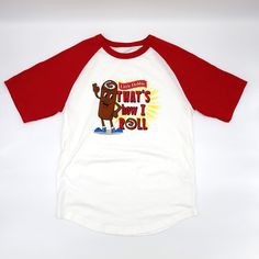 Front view of the Little Debbie Swissy 'That's How I Roll' T-shirt, featuring Swissy the mascot, and the phrase 'That's How I Roll' prominently displayed on the front, with radiant red raglan sleeves. Red Fun T-shirt With Funny Print, Red Cotton Novelty T-shirt, Red Novelty Cotton T-shirt, Fun Red T-shirt With Funny Print, Red T-shirt With Funny Print, White Novelty Cotton T-shirt, White Cotton Novelty T-shirt, Cotton Novelty T-shirt With Slogan, Novelty Cotton T-shirt With Slogan