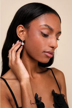 Add an expensive vibe to any date-night look with the Lulus Posh Drama Gold Rhinestone Teardrop Earrings! Shiny gold-toned metal shapes these stunning earrings that have a teardrop-shaped silhouette with a halo of clear rhinestones along the posts surrounding the rhinestone focals. Post backs. 1" long. 70% Brass, 30% Cubic Zirconia. Imported. Lulus | Posh Drama Gold Rhinestone Teardrop Earrings. Chic Teardrop Earrings For Party, Chic Metal Teardrop Earrings For Formal Occasions, Chic Teardrop Dangle Earrings For Party, Chic Metal Teardrop Drop Earrings, Glamorous Evening Teardrop Drop Earrings, Gold Teardrop Earrings For Evening Chic Style, Glamorous Metal Teardrop Earrings, Chic Teardrop Earrings For Evening, Metal Teardrop Earrings For Evening