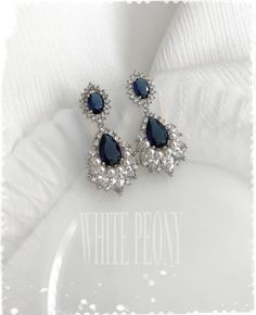 "Something Blue for your special day Vintage Old Hollywood inspired sapphire blue crystal fan & drop / pearl chandelier earrings : \"ERIN pearl\" by ©White Peony by KC. Beautiful and very sparkling crystal chandelier earrings are made of AAA quality sapphire blue and clear Cubic Zirconia (zircon, CZ) Simulated Diamond / white gold plated components and hand embellished with small 3mm Swarovski crystal pearl (photo shown in \"white\"). Or also you can choose \"no pearl\" embellish. Please not Elegant Sapphire Crystal Dangle Earrings, Elegant Blue Crystal Earrings, Elegant Blue Drop Crystal Earrings, Elegant Blue Cubic Zirconia Chandelier Earrings, Elegant Blue Crystal Chandelier Earrings, Elegant Blue Crystal Wedding Earrings, Elegant Blue Crystal Earrings For Wedding, Elegant Blue Chandelier Earrings For Wedding, Elegant Blue Crystal Teardrop Earrings