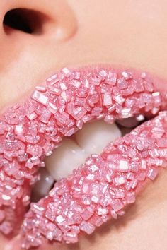 a woman's lips with pink glitter on them