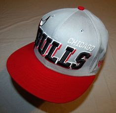 a chicago bulls baseball cap on a bed