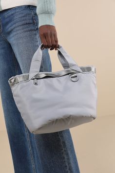 Keep your on-the-go look on point with the Versatile Aesthetic Grey Nylon Utility Tote! Sleek nylon fabric, with a slightly puffy effect throughout, shapes this tote-style bag that has a flat bottom and slender fabric tote handles. Shiny nylon cording creates utilitarian-chic trim throughout, and a zippered top closure opens to reveal a spacious interior with a zippered sidewall pocket. Matching adjustable nylon strap can be attached to wear as a crossbody. Bonus zippered round mini pouch offers Solid Nylon Bags For On-the-go, On-the-go Nylon Bags, Versatile Solid Color Nylon Shoulder Bag, Spring Nylon Shoulder Bag With Double Handle, Summer Nylon Shoulder Bag For On-the-go, Gray Nylon Shoulder Bag, Summer Nylon Bag In Solid Color, Solid Nylon Summer Bag, Trendy Packable Nylon Shoulder Bag