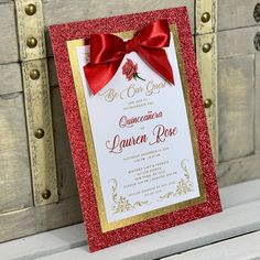 a red and gold wedding card with a bow