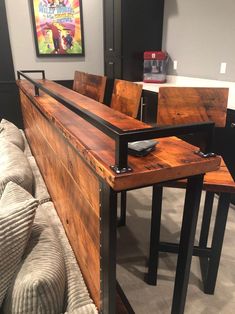 a wooden table sitting next to two stools on top of a carpeted floor