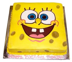 a yellow spongebob cake with blue eyes and brown spots on it's face