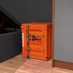 an orange box sitting on top of a hard wood floor