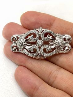 Very beautiful art deco 14k solid white gold natural diamond pin brooch. (( Can be modified to pendant.)) Weight: 10.6 grams Size appx: 44*25 mm Total diamond weight:1.19 Ct Center stone size: 3.3 mm, 0.15 Ct Diamond clarity and color: SI1-2/ G Mounted diamonds are calculated by measurements and might be different more or less. Please add me to your Favorites list Classic Diamond Brooch In White Gold, Classic White Gold Diamond Brooch, Classic White Gold Diamond Brooches, Art Deco White Gold Diamond Brooch, Luxury Silver Brilliant Cut Brooches, Favorites List, Diamond Clarity, Pin Brooch, Vintage Art Deco