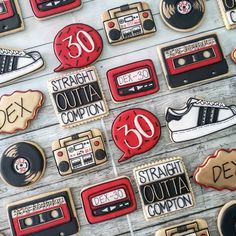 cookies decorated with various types of audio cassettes and tape recorders are arranged on a table