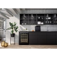 a modern kitchen with black cabinetry and wine bottles on the counter, along with a potted plant