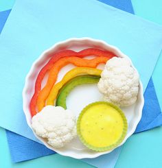 there is a plate with cauliflower, carrots and a rainbow in it