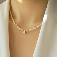 Drape yourself in elegance with our Personalized Letter Necklace adorned with natural pearls and 14/20 gold-filled beads, a graceful tribute to refined simplicity. Ideal for everyday wear, this necklace adds a touch of sophistication to your look. Whether for yourself or a loved one, it makes for a thoughtful and personalized gift, capturing the essence of timeless beauty in every letter and pearl. *Personalized pieces take between 2-4 business days to ship* Handcrafted in USA DETAILS: Material: Elegant Gold Jewelry With Letter Beads, Gold Anniversary Letter Beads Necklace, White Pearl Necklace With Initial Pendant, Elegant Pearl Jewelry With Letter Beads, Elegant Letter Beads Necklace For Mother's Day, Elegant Gold Pearl Necklace With Letter Beads, Gold Pearl Necklace With Charm For Mother's Day, Gold Beaded Necklace With Pearl Chain For Anniversary, Gold Beaded Pearl Chain Necklace For Anniversary