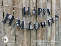 a happy halloween banner hanging on a fence