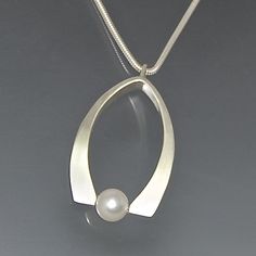 Petal Pearl Pendant by Susan Panciera: Silver & Pearl Necklace available at www.artfulhome.com Modern Teardrop Jewelry With Pearl Charm, Modern Jewelry With Pearl Charm, Modern Pearl White Jewelry With Pearl Drop, Modern Pearl Charm Jewelry, Modern Pearl Jewelry With Pearl Charm, Modern Pearl Pendant Necklace, Modern Pearl White Jewelry With Pearl Chain, Modern White Gold Jewelry With Pearl Charm, Modern Akoya Pearl Jewelry With Pearl Charm