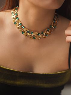 Description: Elevate your style with the Era Leaf Vintage Necklace , an exquisite piece designed to capture attention and radiate elegance. Crafted from high-quality gold-plated brass, this necklace features a stunning arrangement of emerald green gemstones set in a unique leaf-inspired design. The brilliant stones add a touch of luxury and sophistication, making it perfect for any special occasion or a glamorous night out. The adjustable chain ensures a comfortable fit, while the intricate detailing showcases exceptional craftsmanship. Details: Material: Gold-plated brass Gemstones: Emerald green crystals Length: 39cm with a 9cm extension chain Weight: Approximately 72g Design: Leaf-inspired pattern with a luxurious finish Care Instructions: Avoid contact with water, perfumes, and chemica Pearl Jewelry Necklace, Natural Stones Necklace, Gold Statement Earrings, Natural Stone Jewelry, Natural Stone Bracelets, Anklet Bracelet, Green Gemstones, Anklet Jewelry, Cord Necklace