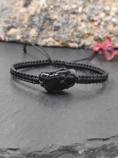 new in shop.  Handmade  adjustable protection bracelet  for everyone, with natural raw black obsidian, knotted with nylon cord.   Bracelet closed length : * 6in (15,4cm)  *  7in(18cm)   * 8in(20cm)     ✧ Please note that no two crystals are alike, therefore shape and size may vary slightly  crystal in length 1,4-1,7cm.  ✧ Each crystal chosen with care and handled with loving intention    ✧ Hand selected natural raw gemstones.  The black obsidian healing properties that are most prominent are its Adjustable Spiritual Obsidian Jewelry, Black Hand Wrapped Spiritual Friendship Bracelets, Black Jewelry With Adjustable Cord For Healing, Adjustable Obsidian Bracelet Jewelry, Casual Black Hand Wrapped Bracelets, Casual Black Hand-wrapped Bracelets, Adjustable Obsidian Bracelet With Natural Stones, Black Spiritual Friendship Bracelets With Adjustable Cord, Adjustable Onyx Bracelet Gift