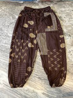 "This is handmade patchwork harem pants trousers made with rayon fabric, This patchwork pant is made for Unisex adults, It is handmade with different patterns. It comes with comfortable elastic waist, 2 pockets and ankle. This is made perfect for a relaxing day at home, working out and yoga. Details - Size - Free size Waist - 26 to 44\" inch Hip - 32 to 46\" inch Length - 38 to 40\" inch Color - Brown Fit - Regular Pattern - Patchwork Material - Rayon fabric Leg Style - Wide leg Wash : Hand wash in cold water and hang dry in the shade." Patchwork Harem Pants, Moodboard Pictures, Yoga Details, Boho Beach Wear, Patchwork Pants, Home Working, Brown Fits, Pants With Pockets, Rayon Fabric