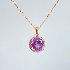 Beautiful amethyst and diamond pendant presented on in 14k gold chain. The amethyst has the most beautiful, crystal clear, watery purple color. A halo setting balances its delicate look with sparkling white diamonds. It's really lovely, and would make a wonderful gift for any special woman in your life - Mother, Daughter, Wife, etc. Approximate dimensions: Amethyst is ~10 mm diameter. Total necklace weight is 3.1 grams. Photos are an important part of item description so please review carefully. Fine Jewelry Purple Diamond Necklace, Purple Diamond Necklace Fine Jewelry, Gold Amethyst Jewelry With Halo Setting, Purple Diamond Necklace In Fine Jewelry Style, Purple Diamond Necklace With Diamond Accents, Yellow Gold Amethyst Jewelry With Halo Setting, Purple Diamond Pendant Necklace, Purple Amethyst Necklace With Diamond Accents, Fine Jewelry Purple Cubic Zirconia Necklaces