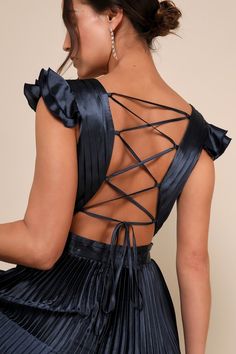 the back of a woman's dress with an open - back and pleated skirt