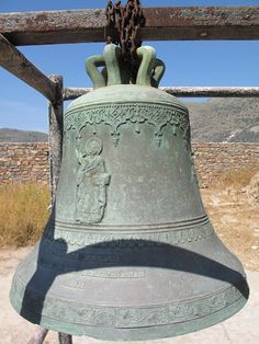 an old bell is sitting on the ground