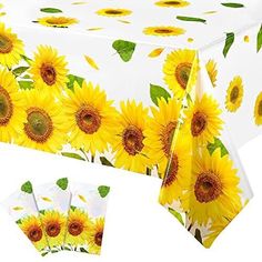 the table cloth has sunflowers on it