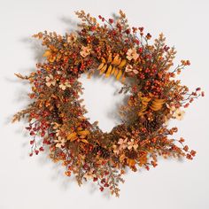 a wreath with autumn leaves and berries